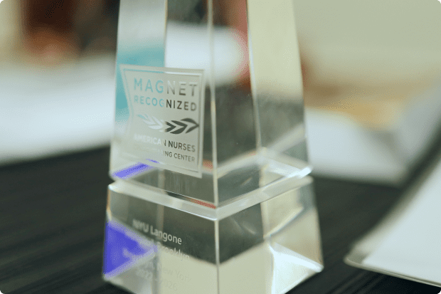 A clear glass Magnet Recognized Hospital award belonging to NYU Langone.