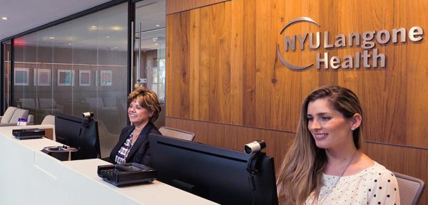 Two female staff members work at their computers at our Patient Access Center in Florida.